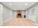 Finished basement area featuring a brick fireplace and double doors to the exterior at 607 Coulwood Dr, Charlotte, NC 28214