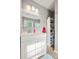 Well-lit bathroom with white vanity, granite countertop, and built-in storage shelves at 607 Coulwood Dr, Charlotte, NC 28214