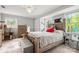 Comfortable bedroom with a ceiling fan, natural light, and a well-organized layout at 607 Coulwood Dr, Charlotte, NC 28214