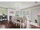 Bright dining area boasts modern lighting, elegant wainscoting, and a cozy fireplace at 607 Coulwood Dr, Charlotte, NC 28214