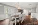 Stylish dining room with French doors and modern lighting, connected to kitchen and living space at 607 Coulwood Dr, Charlotte, NC 28214