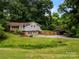 Charming home with a lush, green lawn and a detached two-car carport at 607 Coulwood Dr, Charlotte, NC 28214