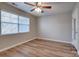 Bright bedroom with a ceiling fan and a large window providing natural light at 623 Olmsted Park Pl # D, Charlotte, NC 28203