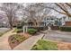 An apartment complex exterior with manicured lawns, seasonal flowers, and visible signage at 623 Olmsted Park Pl # D, Charlotte, NC 28203