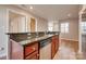 Granite countertops adorn the kitchen, complete with stainless steel dishwasher, sink, and wood cabinets at 623 Olmsted Park Pl # D, Charlotte, NC 28203