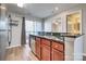 Well-equipped kitchen featuring granite countertops, a stainless steel dishwasher, and a door to the outdoor deck at 623 Olmsted Park Pl # D, Charlotte, NC 28203