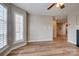 Inviting living room featuring large window with hardwood floors and a ceiling fan at 623 Olmsted Park Pl # D, Charlotte, NC 28203