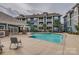 An outdoor community pool with lounge seating and views of apartment building at 623 Olmsted Park Pl # D, Charlotte, NC 28203