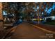Charming tree-lined street showcasing inviting homes with well-maintained landscaping and welcoming curb appeal in the evening at 623 Olmsted Park Pl # D, Charlotte, NC 28203