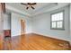 Well-lit bedroom with hardwood floors, tray ceiling, and a large window with shutters at 750 Waterscape Ct, Rock Hill, SC 29730