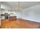 Open floor plan with hardwood floors, kitchen island, and modern appliances at 750 Waterscape Ct, Rock Hill, SC 29730