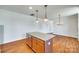 Open kitchen with a granite-topped island, hardwood floors, and pendant lighting at 750 Waterscape Ct, Rock Hill, SC 29730