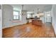 Open kitchen with hardwood floors, granite counters, and stainless steel appliances at 750 Waterscape Ct, Rock Hill, SC 29730