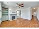 Open living room featuring hardwood floors, a fireplace, and a built-in bookcase at 750 Waterscape Ct, Rock Hill, SC 29730