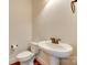 Elegant powder room featuring pedestal sink, toilet, and hardwood floors at 750 Waterscape Ct, Rock Hill, SC 29730
