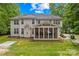 Backyard view with a screened-in porch, spacious yard and basketball court at 763 Evans Manor Dr, Weddington, NC 28104