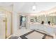 Bright bathroom with large vanity, glass enclosed shower and access to walk-in closet at 763 Evans Manor Dr, Weddington, NC 28104