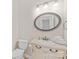 Neat powder room features a stylish vanity with a decorative mirror and ample lighting at 763 Evans Manor Dr, Weddington, NC 28104