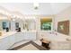 Luxury bathroom featuring a large tub, separate vanity areas, and natural light at 763 Evans Manor Dr, Weddington, NC 28104