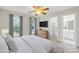 Cozy bedroom with a ceiling fan, two windows, dresser, and access to bathroom and closet at 763 Evans Manor Dr, Weddington, NC 28104