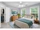 Relaxing bedroom is adorned with natural light, soft blue walls and a large dresser for ample storage at 763 Evans Manor Dr, Weddington, NC 28104