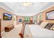 Spacious main bedroom features a sitting area, TV, large windows and tray ceiling at 763 Evans Manor Dr, Weddington, NC 28104