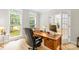Well-lit office with hardwood floors, a large desk, and views of the yard at 763 Evans Manor Dr, Weddington, NC 28104