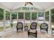 Inviting sunroom boasting large windows, comfortable wicker furniture and backyard views at 763 Evans Manor Dr, Weddington, NC 28104
