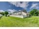 A well-maintained townhome backyard features a white fence, a lush green lawn, and mature trees at 841 Lacebark Dr, Rock Hill, SC 29732