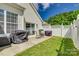 Secluded backyard with a patio, seating, and lawn, enclosed by a privacy fence, perfect for relaxation at 841 Lacebark Dr, Rock Hill, SC 29732