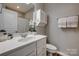 Bathroom with white vanity, framed mirror, updated lighting, and hardwood floors at 841 Lacebark Dr, Rock Hill, SC 29732
