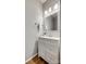 Bathroom with white vanity, framed mirror, updated lighting, and hardwood floors at 841 Lacebark Dr, Rock Hill, SC 29732