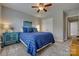Inviting bedroom featuring a plush blue bed, complemented by a ceiling fan, soft lighting, and stylish decor at 841 Lacebark Dr, Rock Hill, SC 29732
