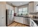 Bright kitchen features stainless steel appliances, granite countertops, and white cabinetry at 841 Lacebark Dr, Rock Hill, SC 29732