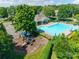 Community pool and playground nestled among mature trees, offering a delightful recreational area at 841 Lacebark Dr, Rock Hill, SC 29732