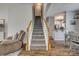 Carpeted staircase with white railings leads to the upper level, enhancing the home's architectural design at 841 Lacebark Dr, Rock Hill, SC 29732