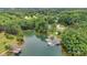 Aerial view of a waterfront home with mature trees and a private dock at 8506 Graham Rd, Denver, NC 28037