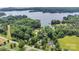 Aerial view of the property and surrounding neighborhood showing lake access and wooded areas at 8506 Graham Rd, Denver, NC 28037