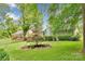 Charming home exterior with a landscaped backyard and mature trees at 8506 Graham Rd, Denver, NC 28037