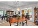 Bright dining room area offering open view of kitchen and mirrored wall at 8506 Graham Rd, Denver, NC 28037