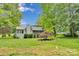 Exterior of a green home with a landscaped yard at 8506 Graham Rd, Denver, NC 28037