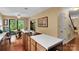 Kitchen featuring an island with cooktop, eat-in dining area, and staircase access at 8506 Graham Rd, Denver, NC 28037