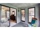 Relaxing sunroom featuring large sliding glass doors and windows with a comfortable chair at 8506 Graham Rd, Denver, NC 28037