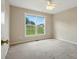 Bright, carpeted bedroom with a ceiling fan and large window offering plenty of natural light at 924 Secrest Hill Dr, Monroe, NC 28110
