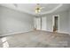 Spacious bedroom featuring a tray ceiling, neutral paint, carpet floors, and multiple closets at 924 Secrest Hill Dr, Monroe, NC 28110
