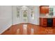 Bright dining area with hardwood floors, large windows, and a door leading to the outside at 924 Secrest Hill Dr, Monroe, NC 28110