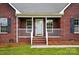 Close up of the brick facade and cozy front porch with painted white railing at 924 Secrest Hill Dr, Monroe, NC 28110