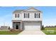 Two-story home with stone accents, a two-car garage, and a welcoming front porch at 925 Two Brothers Ln, York, SC 29745