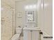 Well-lit bathroom with a tile shower, white vanity, and decorative mirror at 1001 Kingbird Ln # 15, Clover, SC 29710
