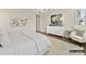 Inviting bedroom with white bedding, decorative wall art, and a comfortable accent chair at 1001 Kingbird Ln # 15, Clover, SC 29710